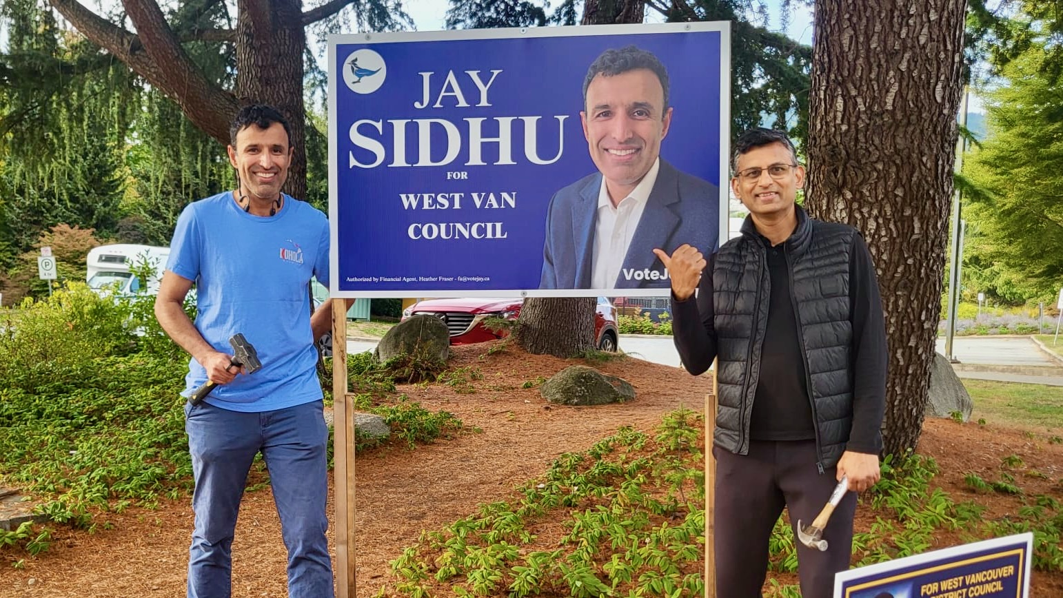 Jay Sidhu and a volunteer with a Jay Sidhu for West Van Council election sign