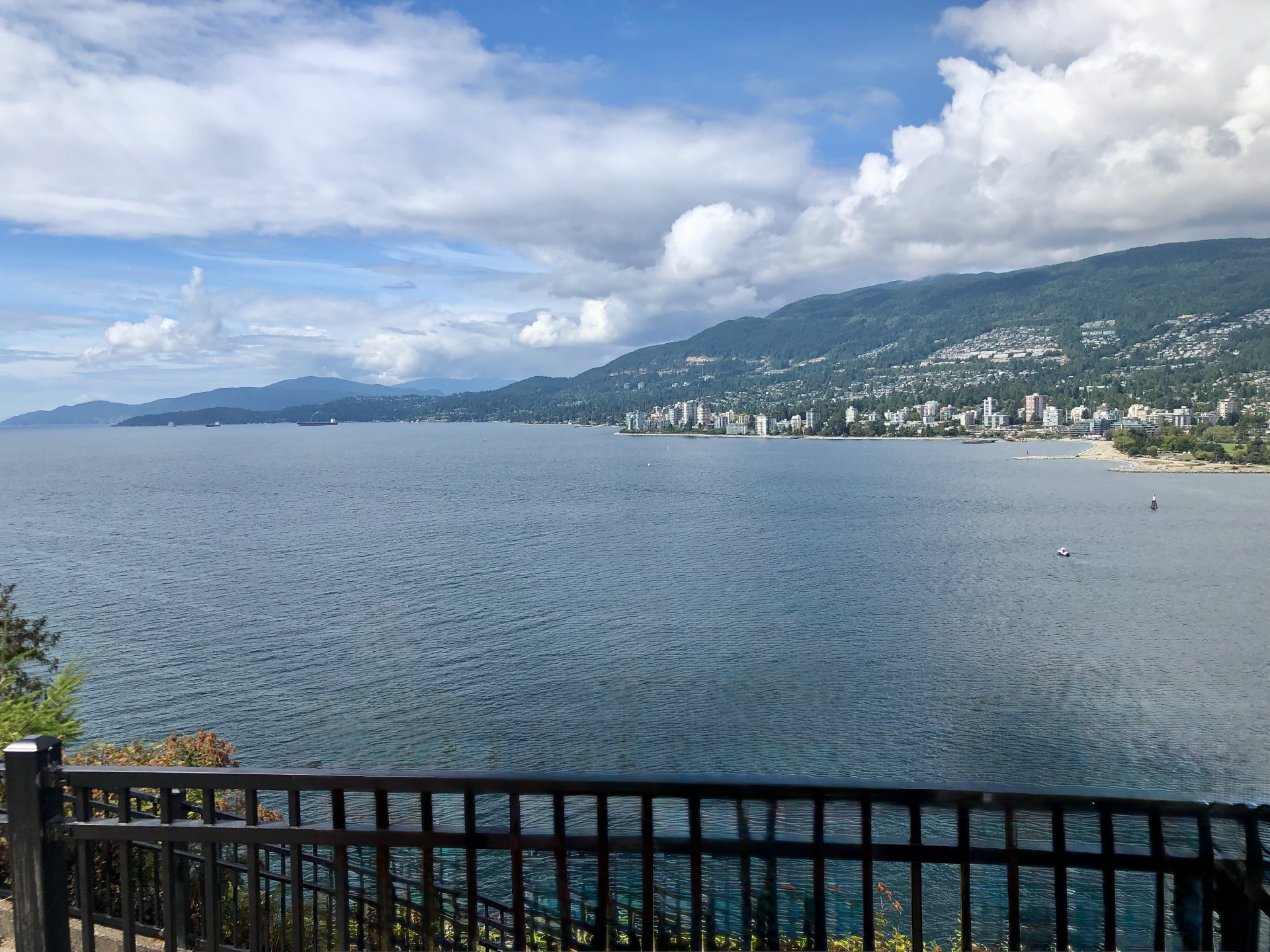 West Vancouver coastline viewed from the waterfront, with mountains and forested shoreline